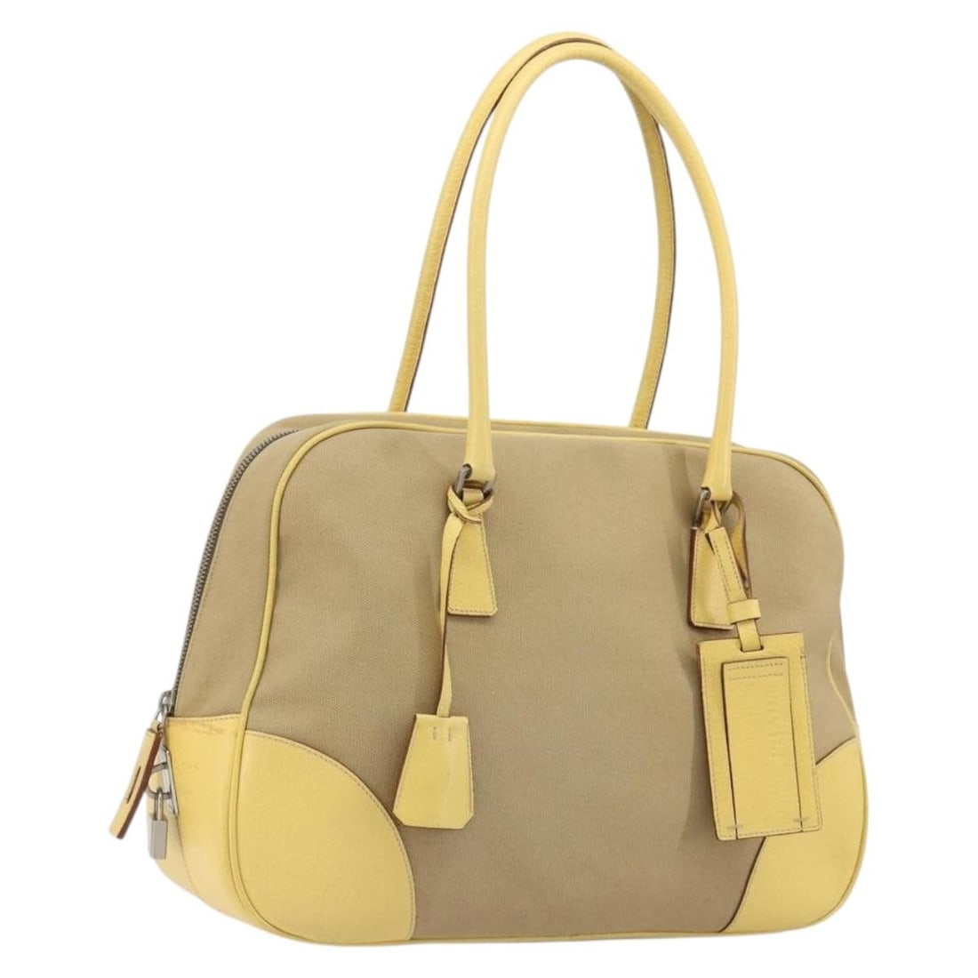 Prada Beige Canvas Handbag with Padlock Key Clochette: Prada Beige Canvas Handbag with Padlock Key Clochette A beige and silver Prada handbag made from canvas, presented in heavily used condition. It includes a padlock, two keys, a clochette, and a name t