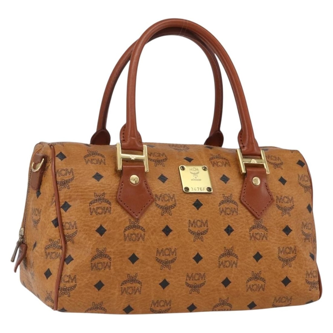 Brown PVC Leather Boston Bag by MCM Vicetos Logogram Germany: Brown PVC Leather Boston Bag by MCM Vicetos Logogram Germany This is an authentic MCM Boston Bag featuring the iconic Vicetos logogram design. Crafted from brown and gold PVC leather, the bag showcase
