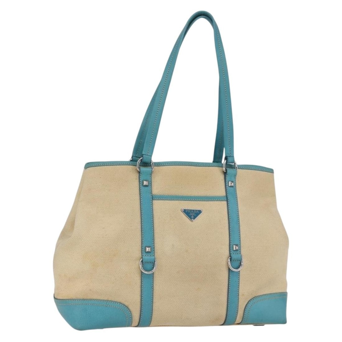 Beige and Silver Canvas PRADA Tote Bag from Italy: Beige and Silver Canvas PRADA Tote Bag from Italy This PRADA tote bag features a beige and silver canvas exterior and is made in Italy. The bag shows significant signs of use, including loss of shape,