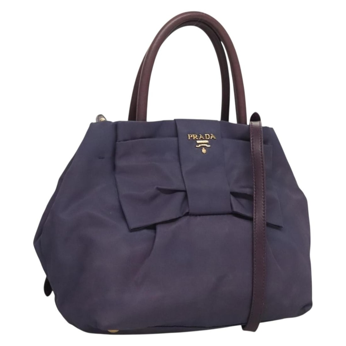 Prada Purple Nylon 2way Hand Bag Gold Tone Hardware: Prada Purple Nylon 2way Hand Bag Gold Tone Hardware A Prada nylon handbag in purple with gold-tone hardware, designed as a 2-way style for hand or shoulder carry. It was made in Italy and is offered i