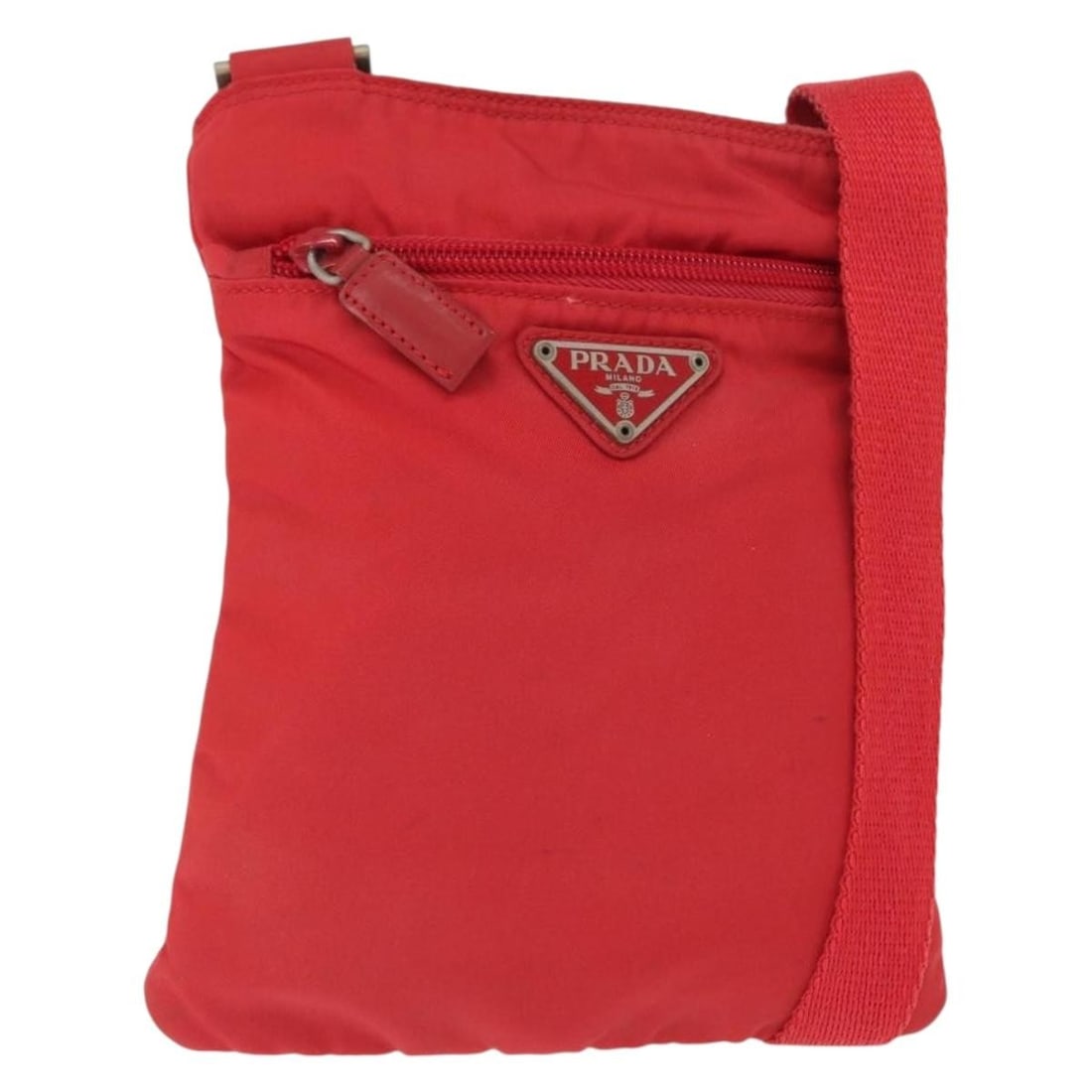 Prada Red Nylon Shoulder Bag with Guarantee Card Italy: Prada Red Nylon Shoulder Bag with Guarantee Card Italy This PRADA shoulder bag is crafted from durable red nylon and features an adjustable strap for versatile carrying options. Made in Italy, the bag