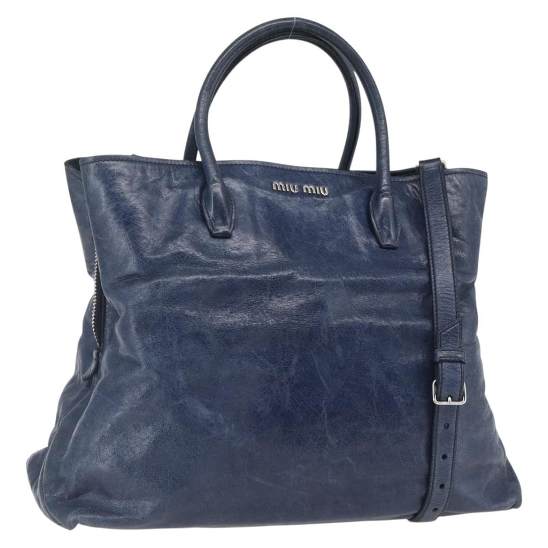 Miu Miu Navy Leather 2 Way Handbag with Shoulder Strap: Miu Miu Navy Leather 2 Way Handbag with Shoulder Strap Miu Miu 2-way handbag in navy leather with silver-tone accents. Made in Italy, this women's bag includes a shoulder strap and can be carried by h