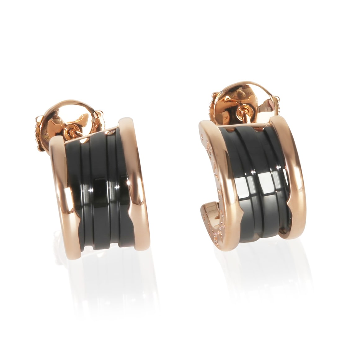 B.zero1 18k Rose Gold Ceramic Hoop Earrings by BVLGARI: B.zero1 18k Rose Gold Ceramic Hoop Earrings by BVLGARI These BVLGARI B.zero1 hoop earrings are crafted from 18k rose gold and ceramic, featuring a sleek pink color. Designed for a unisex audience, the