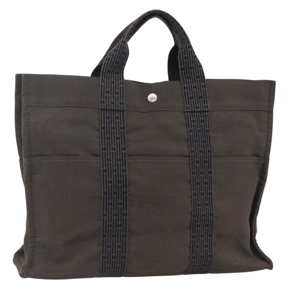 Her Line canvas tote in gray and silver by Hermes France: Her Line canvas tote in gray and silver by Hermes France This HERMES Her Line tote bag is crafted from gray and silver canvas and features a spacious open-top design. Designed for women, the bag offer