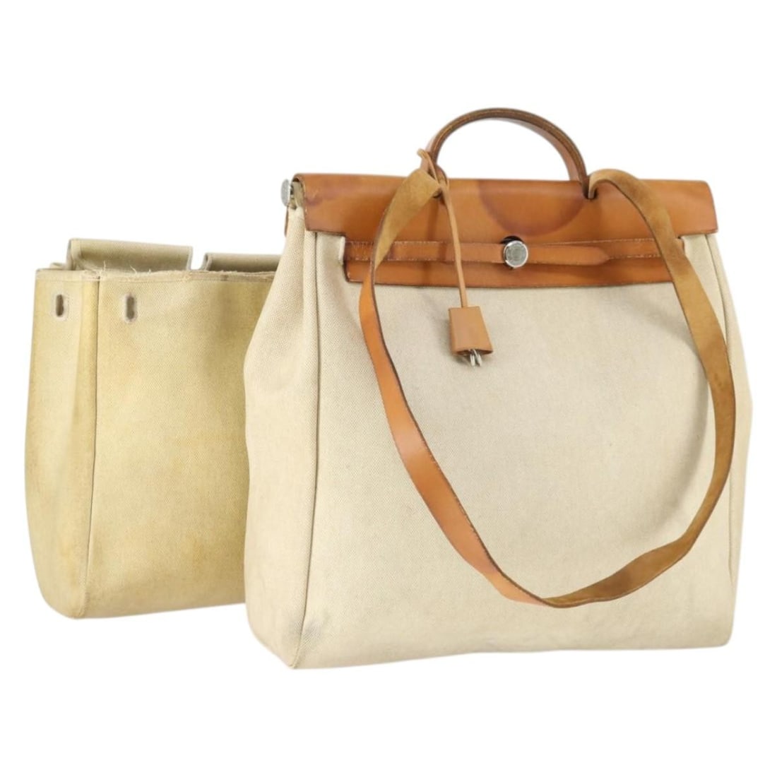 Beige Canvas Her Bag MM by Hermes with Silver Hardware and Accessories: Beige Canvas Her Bag MM by Hermes with Silver Hardware and Accessories This Hermes Her Bag MM is a hand bag crafted from beige canvas with silver-tone accents. It features a spacious interior and come