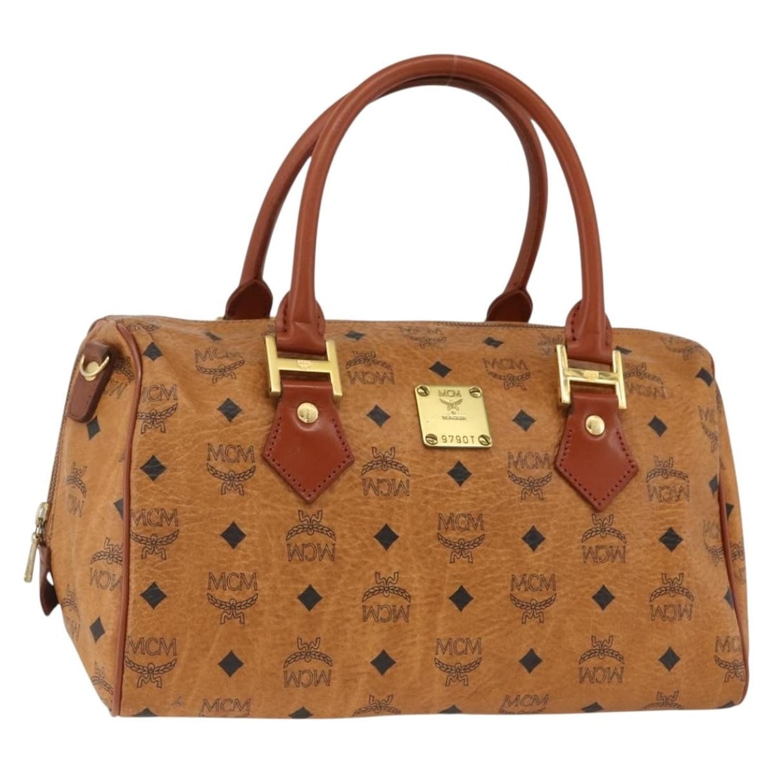 MCM Brown PVC Leather Logogram Handbag with Gold Accents Germany: MCM Brown PVC Leather Logogram Handbag with Gold Accents Germany This MCM handbag features the iconic Vicetos logogram design in brown and gold PVC leather. The bag is designed for women and includes 