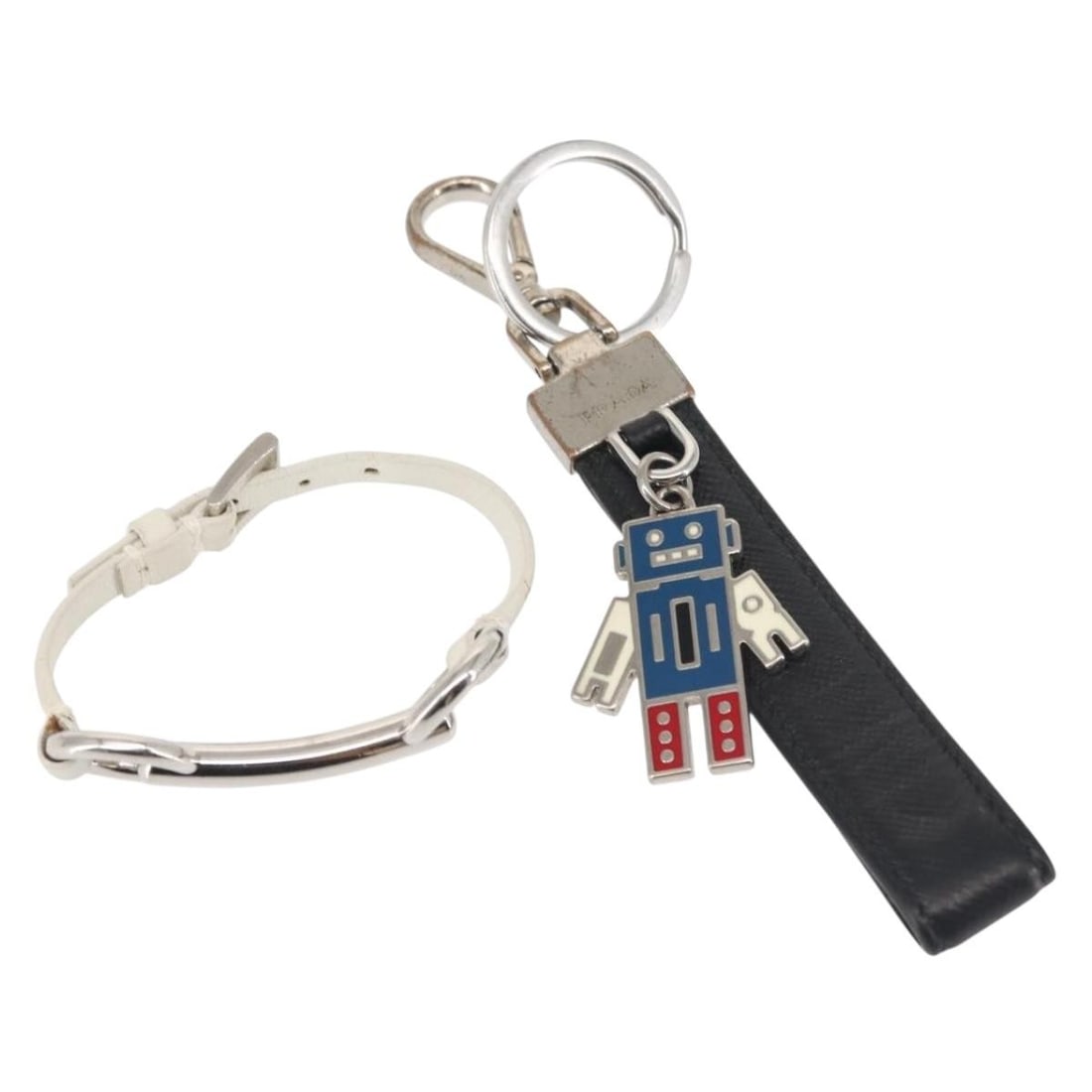 PRADA Black Silver Metal Charm Set of 2 Authentic: PRADA Black Silver Metal Charm Set of 2 Authentic This authentic PRADA charm set features a stylish combination of black and silver tones, crafted from durable metal. The charms showcase a chic design