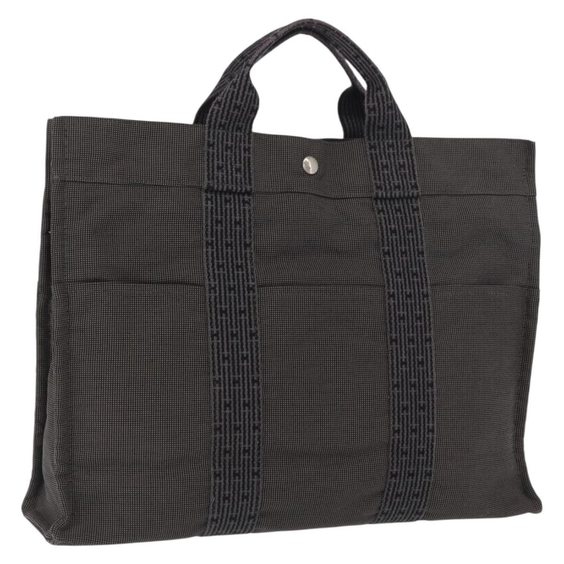 Hermes Her Line MM Gray Canvas Womens Handbag Silver Tone Hardware: Hermes Her Line MM Gray Canvas Womens Handbag Silver Tone Hardware This Hermes Her Line MM handbag is crafted from gray and silver canvas, designed for women. The bag features a spacious interior and 