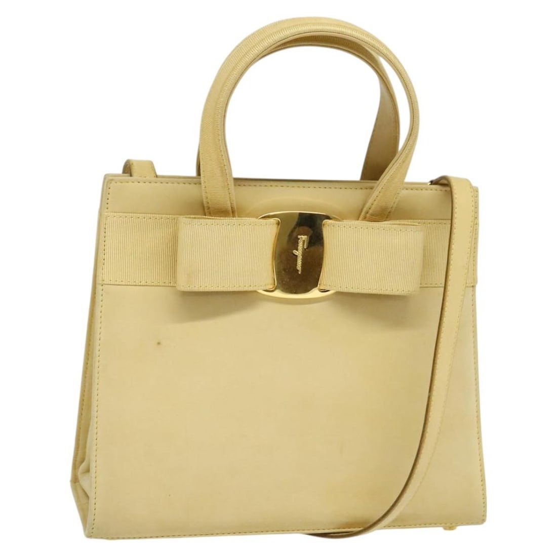 Salvatore Ferragamo Vala Suede Handbag Beige Gold Tone Strap: Salvatore Ferragamo Vala Suede Handbag Beige Gold Tone Strap A Salvatore Ferragamo Vala hand bag in beige and gold suede, made in Italy. It comes with a shoulder strap and features a compact silhouett