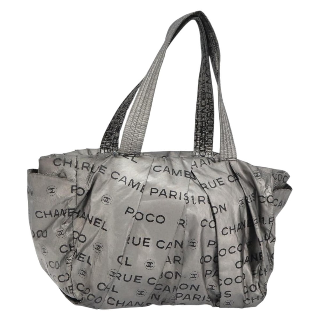Silver Nylon Unlimited Tote by CHANEL with CC Logo: Silver Nylon Unlimited Tote by CHANEL with CC Logo This CHANEL Unlimited tote bag is crafted from silver nylon and features the iconic CC logo. Made in Italy, the bag has a spacious interior, making i