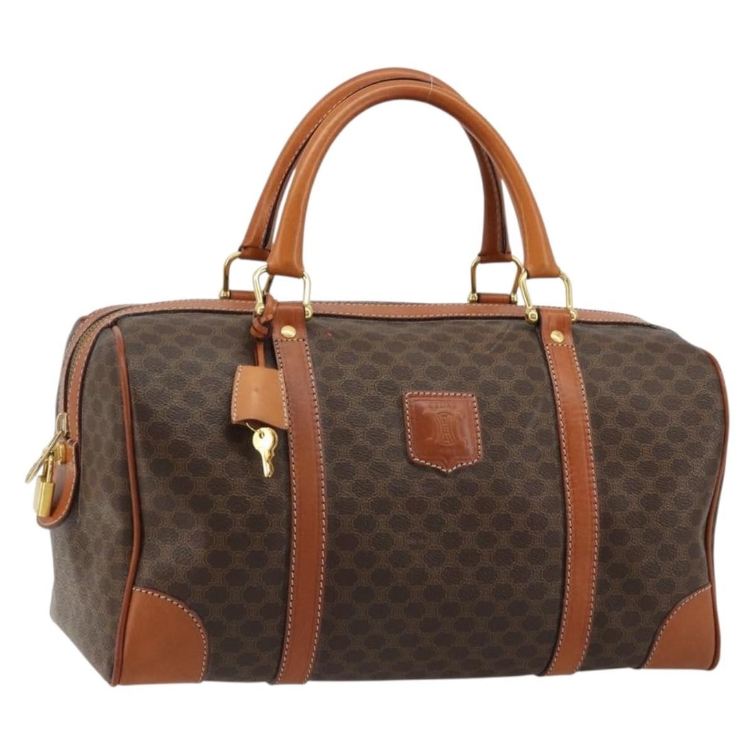 CELINE Macadam Boston Bag Brown PVC Leather with Padlock Keys: CELINE Macadam Boston Bag Brown PVC Leather with Padlock Keys Celine Macadam canvas Boston bag in brown with gold-tone accents, crafted with PVC leather trim. This women's handbag includes a padlock, 
