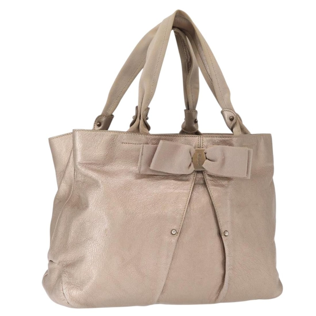 Beige Leather Vala Tote by Salvatore Ferragamo Italy: Beige Leather Vala Tote by Salvatore Ferragamo Italy This Salvatore Ferragamo Vala tote bag features beige leather construction and offers a spacious interior. Made in Italy, the bag is designed with 