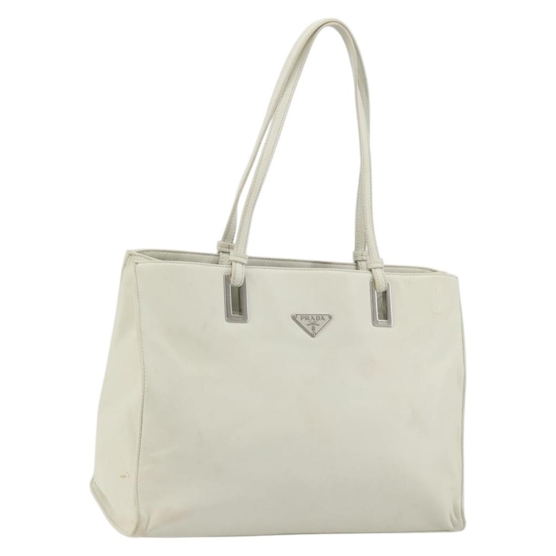 Prada white silver leather tote bag Italy: Prada white silver leather tote bag Italy This PRADA tote bag is crafted from white and silver leather, offering a stylish and functional accessory for women. Made in Italy, the bag features a spaciou