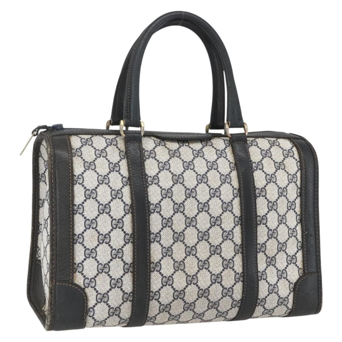 Navy GG Supreme Handbag by Gucci in PVC with Gold Accents: Navy GG Supreme Handbag by Gucci in PVC with Gold Accents This is a Gucci GG Supreme hand bag crafted from navy PVC leather and GG canvas with gold-tone accents. Made in Italy, the bag features a stru