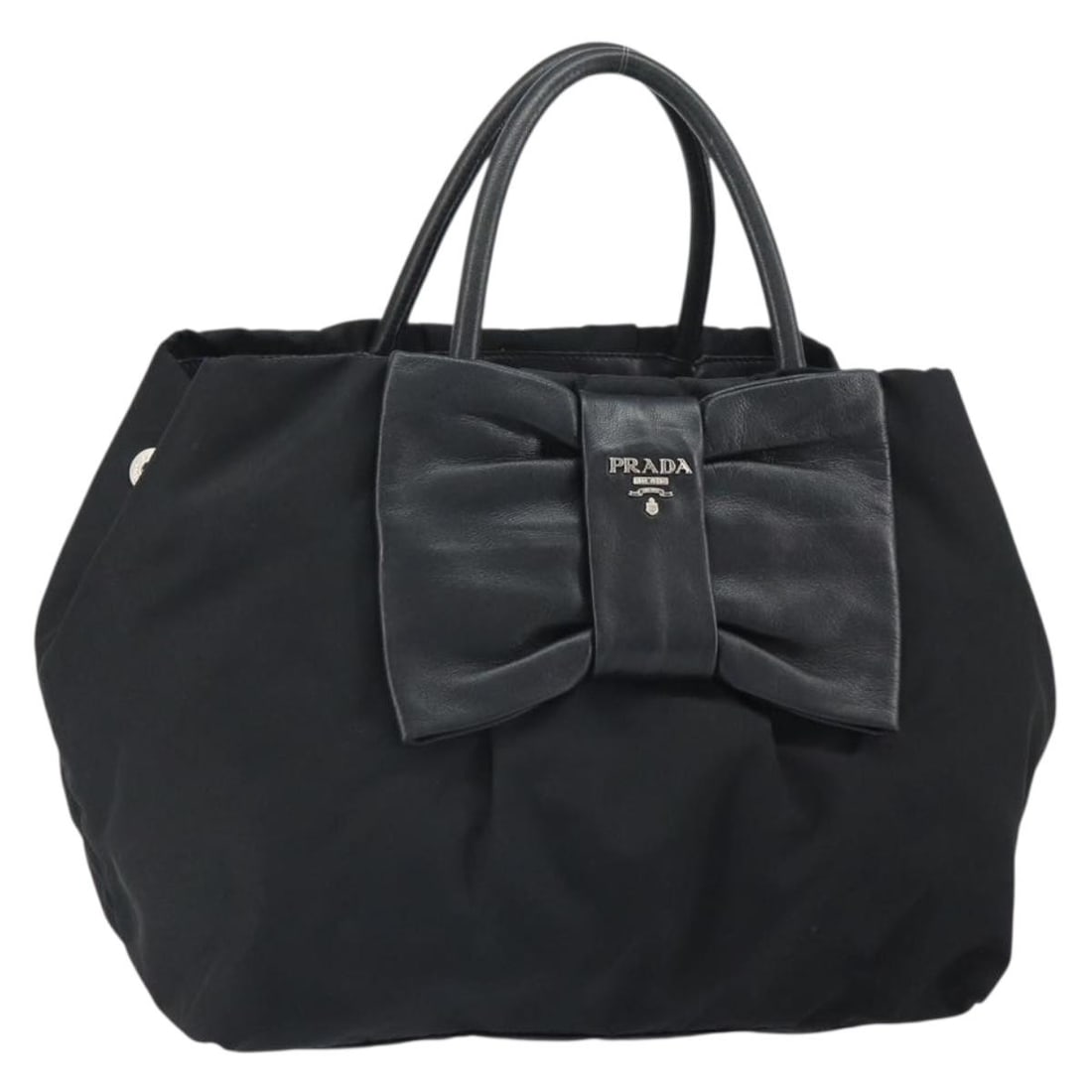 Black Nylon Prada Ribbon Series Leather Trim Handbag Silver Accents: Black Nylon Prada Ribbon Series Leather Trim Handbag Silver Accents This PRADA Ribbon hand bag features a classic black nylon exterior with silver-tone accents and leather detailing. The bag is design