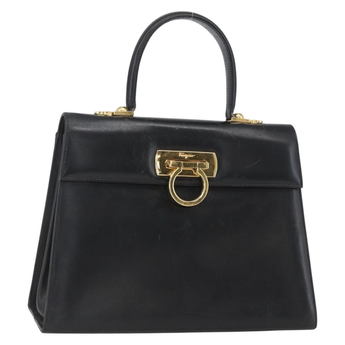 Black Leather Gancini Handbag by Salvatore Ferragamo with Gold Accents: Black Leather Gancini Handbag by Salvatore Ferragamo with Gold Accents This Salvatore Ferragamo Gancini handbag features a black leather exterior with gold-tone accents. The bag is designed with a top