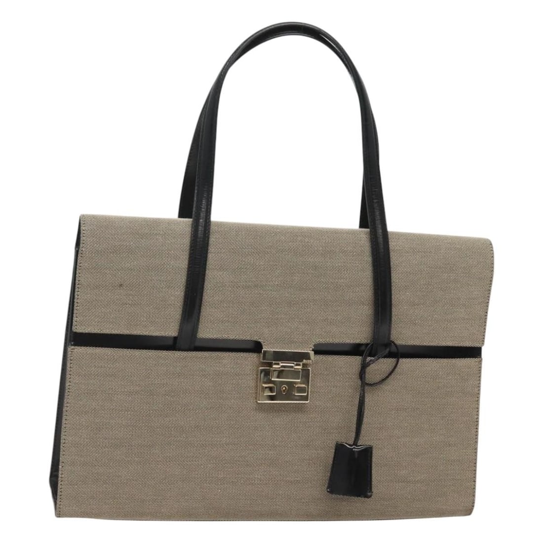 Gucci Beige Gold Canvas Hand Bag with Keys and Clochette: Gucci Beige Gold Canvas Hand Bag with Keys and Clochette This Gucci handbag is crafted from beige and gold canvas, offering a stylish and versatile accessory for women. Made in Italy, it features a sp