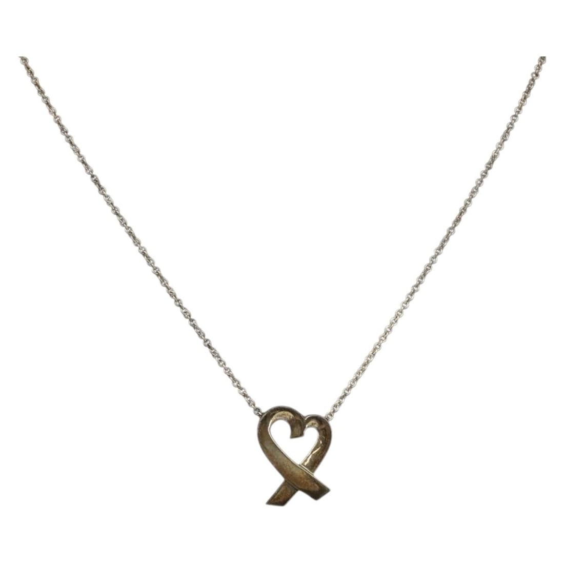 Tiffany Co Loving Heart Sterling Silver Necklace 16.1in: Tiffany Co Loving Heart Sterling Silver Necklace 16.1in Tiffany & Co. Loving Heart necklace in silver for women. This necklace is heavily used and shows surface scratches, with a noticeable metal smel