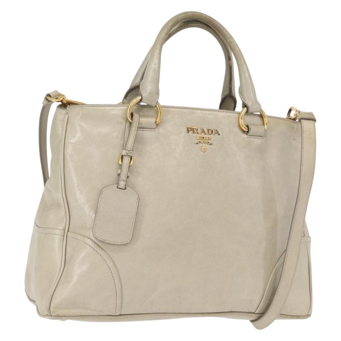 Prada Beige Leather Two Way Handbag with Gold Tone and Shoulder Strap: Prada Beige Leather Two Way Handbag with Gold Tone and Shoulder Strap This PRADA 2-way handbag is crafted from beige and gold leather and can be carried by hand or worn over the shoulder with the incl