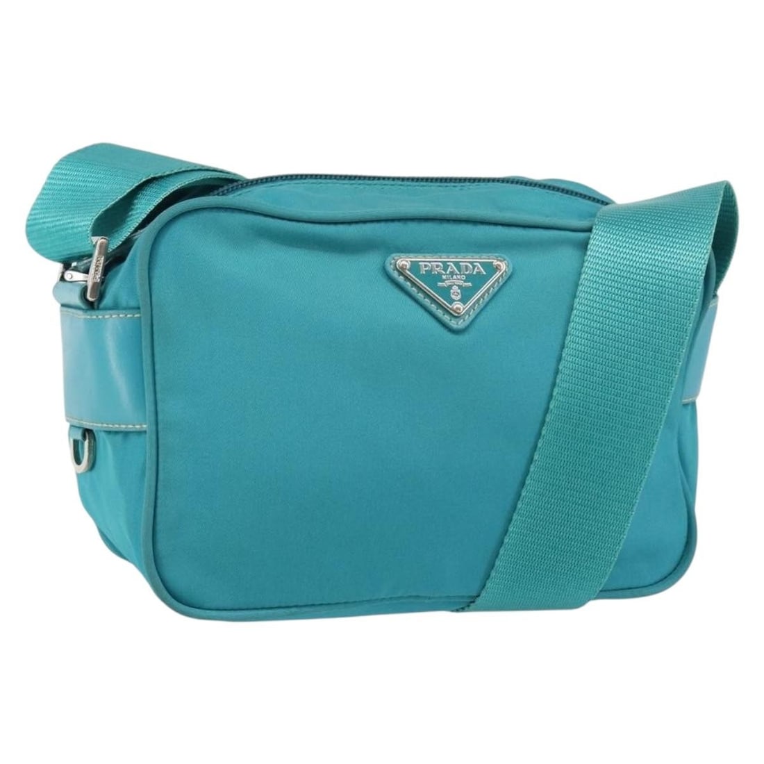 Prada Nylon Shoulder Bag in Turquoise Blue with Silver: Prada Nylon Shoulder Bag in Turquoise Blue with Silver Authentic Prada shoulder bag in turquoise blue nylon with silver-tone accents. Made in Italy, this women's bag features a compact shoulder bag si