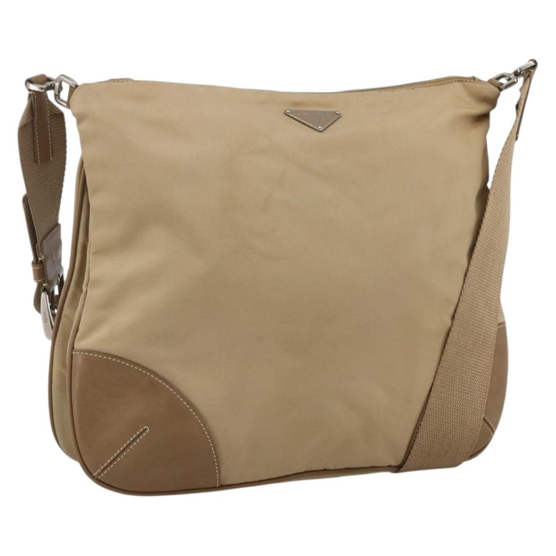 Prada Beige Nylon Shoulder Purse with Silver Tone Accents for Women: Prada Beige Nylon Shoulder Purse with Silver Tone Accents for Women This PRADA shoulder bag is crafted from beige nylon with silver-tone accents. Designed for women, it features a spacious main compar