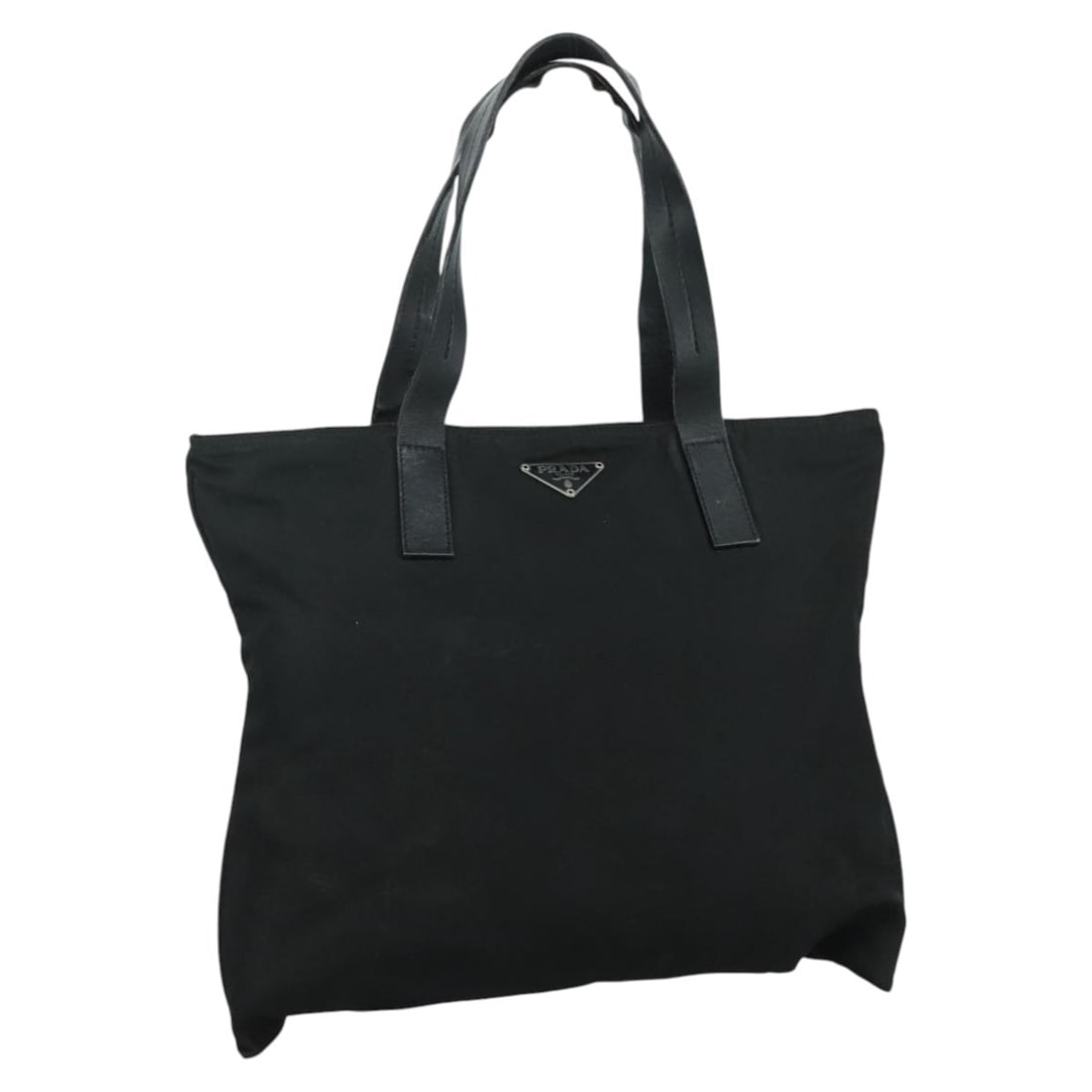 Black Nylon Tote Handbag by Prada Italy: Black Nylon Tote Handbag by Prada Italy This PRADA tote bag features a black nylon exterior with a spacious design, suitable for women. The bag is crafted in Italy and includes dual handles with a dro