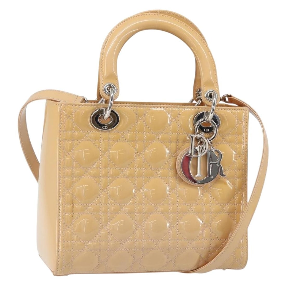 Christian Dior Lady Dior patent leather beige silver handbag with strap: Christian Dior Lady Dior patent leather beige silver handbag with strap This Christian Dior Lady Dior Canage handbag is crafted from beige patent leather with silver-tone accents. Designed for versati