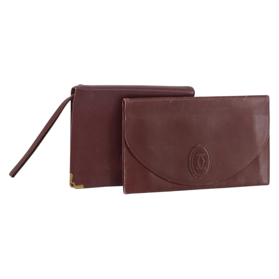CARTIER Bordeaux Leather Clutch Bag Set of 2 Auth: CARTIER Bordeaux Leather Clutch Bag Set of 2 Auth This elegant CARTIER Must Line Clutch Bag is a timeless accessory crafted from high-quality leather in a rich bordeaux hue. Designed for sophisticatio