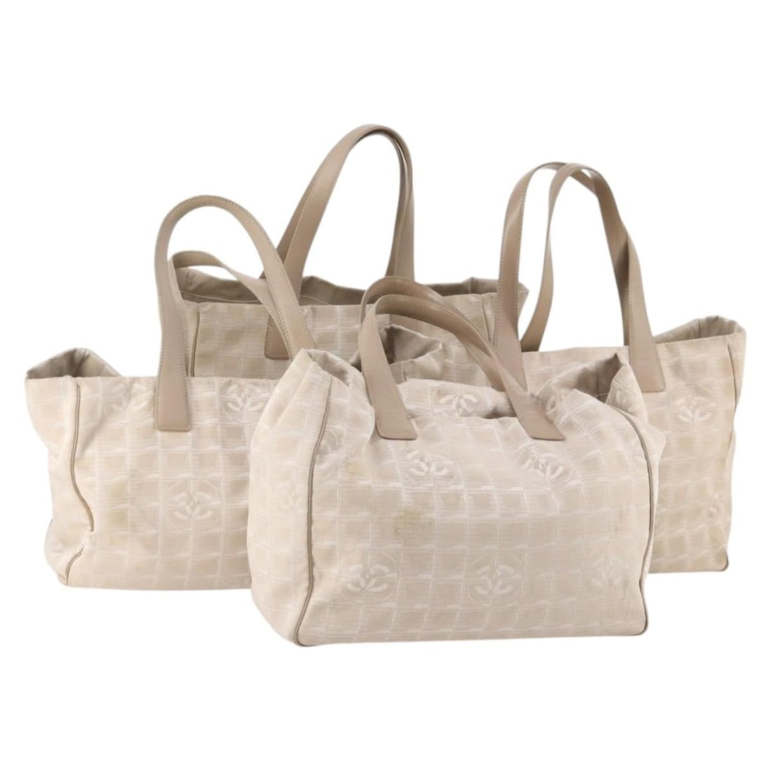4 Piece Beige Nylon Tote Bag Set by CHANEL Made in France: 4 Piece Beige Nylon Tote Bag Set by CHANEL Made in France CHANEL New Travel Line tote bag in beige nylon. This women's tote is made in France and offered as a 4 set sale. Condition is heavily used, wi