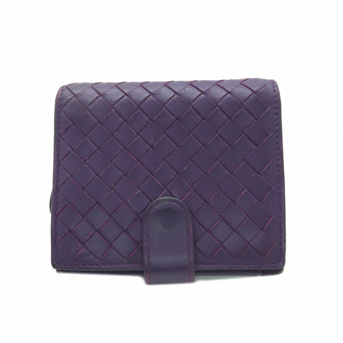 Bottega Veneta Intrecciato Purple Calfskin Bi Fold French Wallet: Bottega Veneta Intrecciato Purple Calfskin Bi Fold French Wallet A BOTTEGA VENETA bi-fold French wallet in purple calfskin (cowhide) leather with the Intrecciato design. It features a hook button clos