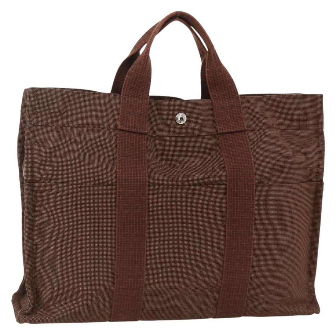 Her Line MM Canvas Tote in Brown and Silver by Hermes: Her Line MM Canvas Tote in Brown and Silver by Hermes This HERMES Her Line MM hand bag is crafted from brown canvas with silver-tone accents. Designed for women, it features a spacious interior and st