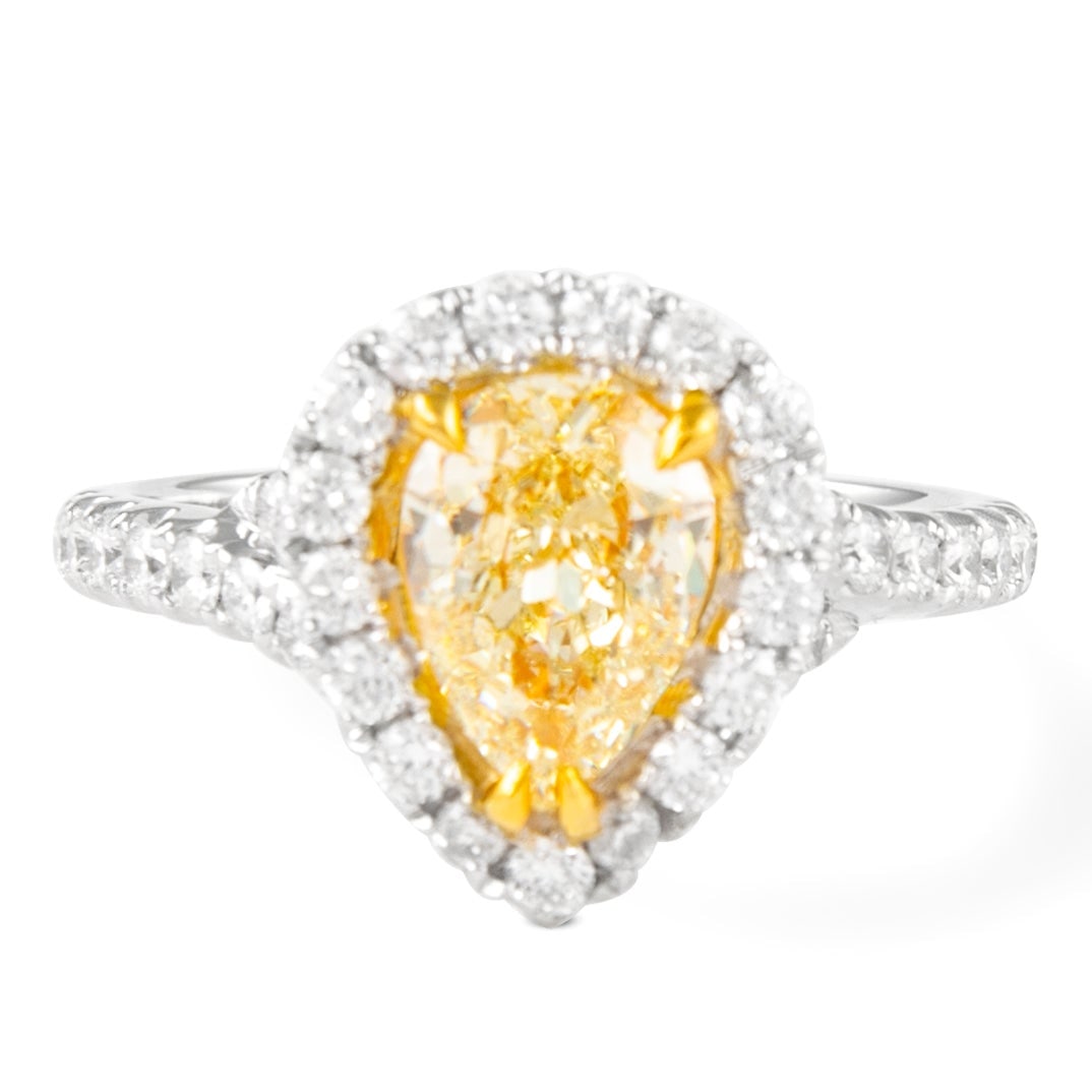1.23ct Fancy Yellow Diamond Halo Ring 18k: 1.23ct Fancy Yellow Diamond Halo Ring 18k This exquisite ring features a stunning EGL certified 1.23ct Fancy Yellow Pear Diamond at its center, elegantly surrounded by a halo of 35 round brilliant dia