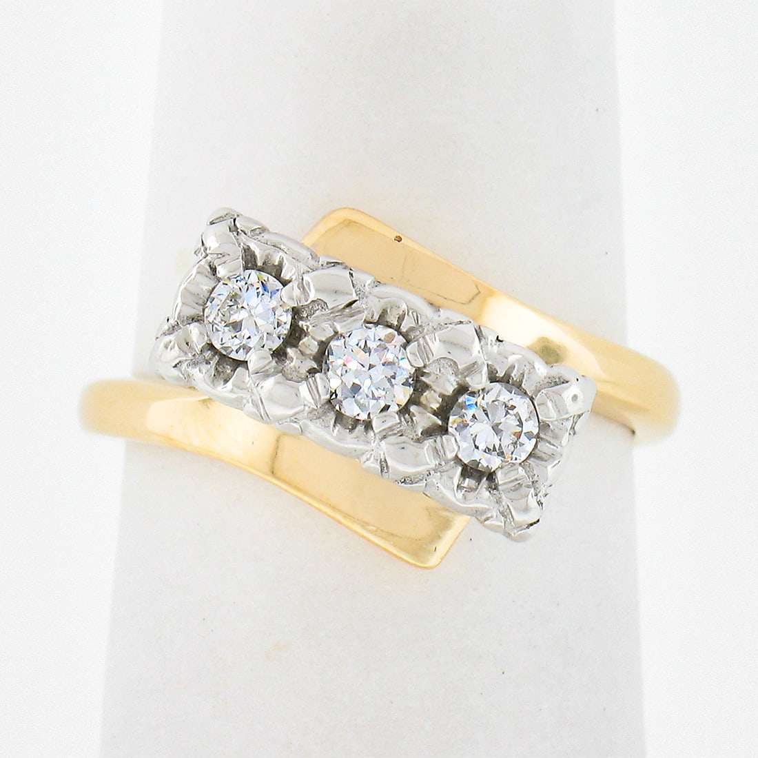 14K Two Tone Diamond Bypass Ring 3 Stones 0.21ctw Vintage: 14K Two Tone Diamond Bypass Ring 3 Stones 0.21ctw Vintage This vintage bypass ring features three round, illusion-prong set natural diamonds with a total carat weight of approximately 0.21. Crafted fr