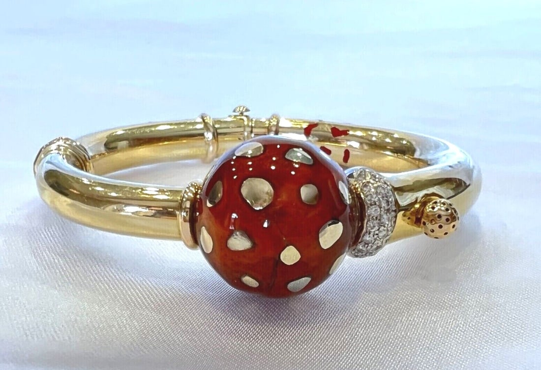 La Nouvelle Bague 18K Gold Enamel Diamond Bangle Bracelet: La Nouvelle Bague 18K Gold Enamel Diamond Bangle Bracelet This exquisite 18K yellow gold bracelet features intricate enamel detailing and sparkling diamonds, creating a stunning bangle style. Crafted