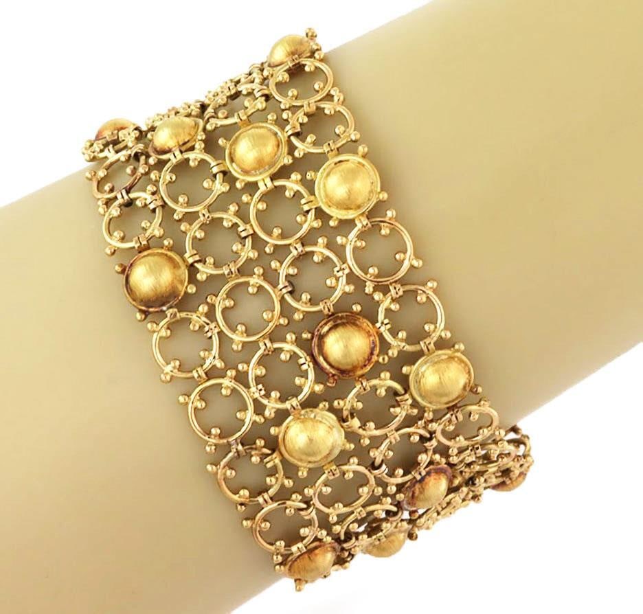Estate 18k Yellow Gold Wide Bracelet 4 Rows Chic Design 53.4g: Estate 18k Yellow Gold Wide Bracelet 4 Rows Chic Design 53.4g This exquisite wide bracelet is crafted from 18k yellow gold, showcasing a chic design with four rows of open circles interspersed with do