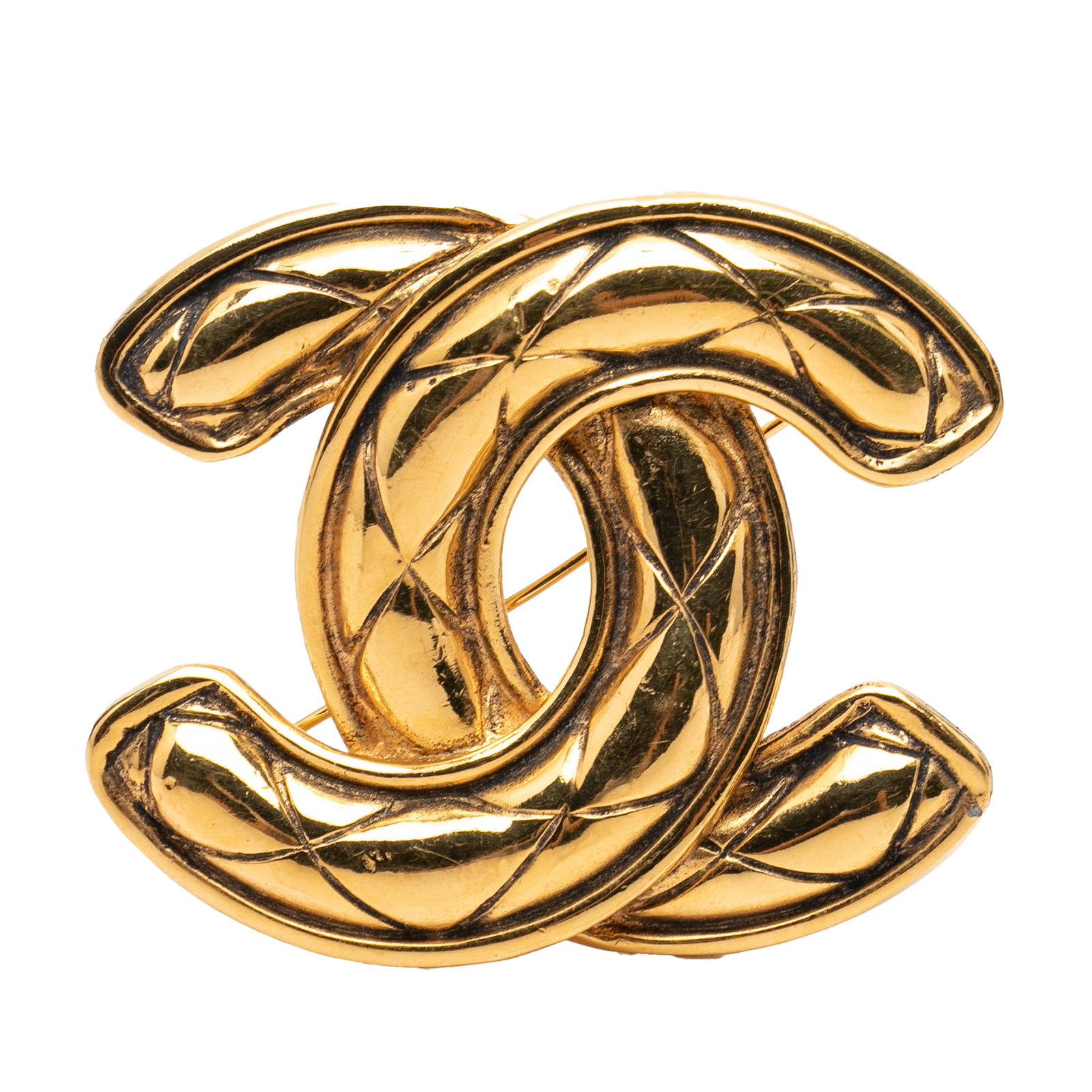 Chanel CC Quilted Gold Plated Brooch: Chanel CC Quilted Gold Plated Brooch Chanel CC Gold Plated Quilted Brooch in gold plated metal with a quilted design and back pin closure. It is a costume accessory made in France and measures 4.80 cm