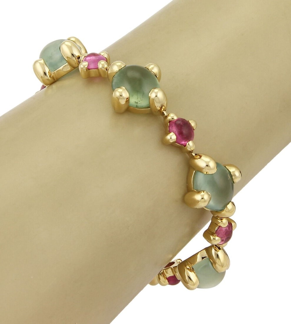 18k Yellow Gold Oval Link Bracelet with Green and Pink Tourmaline: 18k Yellow Gold Oval Link Bracelet with Green and Pink Tourmaline This vintage/estate bracelet is crafted in solid 18k yellow gold and features bold sculptural oval links accented with green and pink 