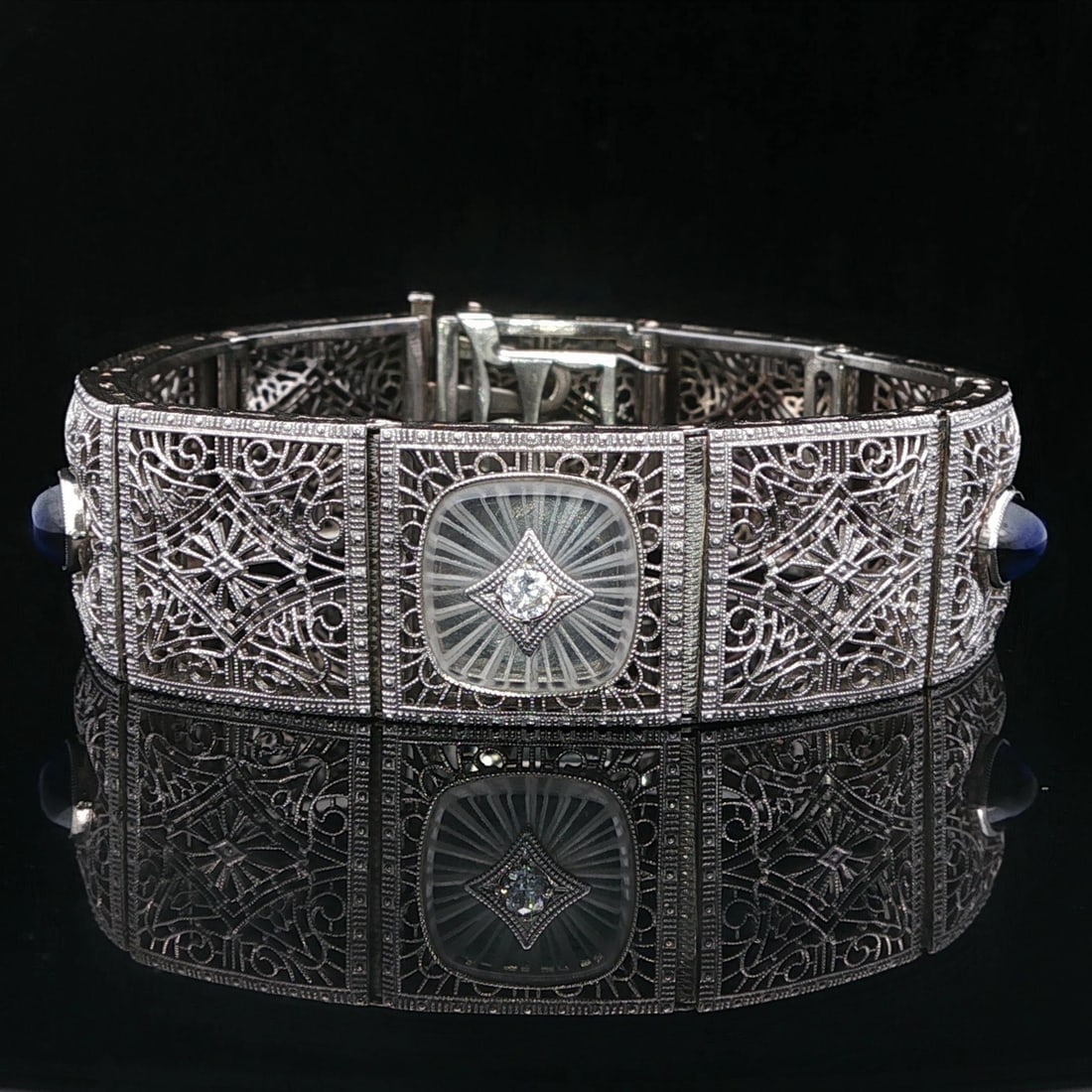 Antique Art Deco 14k White Gold Filigree Bracelet with Diamond and Camphor Glass: Antique Art Deco 14k White Gold Filigree Bracelet with Diamond and Camphor Glass This exquisite Antique Art Deco bracelet showcases a unique blend of materials and craftsmanship. Featuring a stunning 