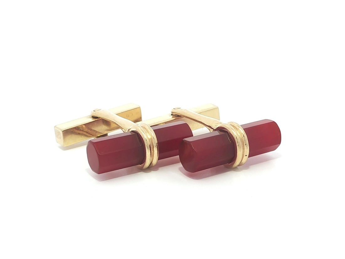 Faceted Carnelian Barrel Cufflinks in 14k Yellow Gold by Tiffany & Co.: Faceted Carnelian Barrel Cufflinks in 14k Yellow Gold by Tiffany & Co. These vintage cufflinks by Tiffany & Co. feature custom-cut, faceted barrel carnelian stones in a rich orange color, set in solid