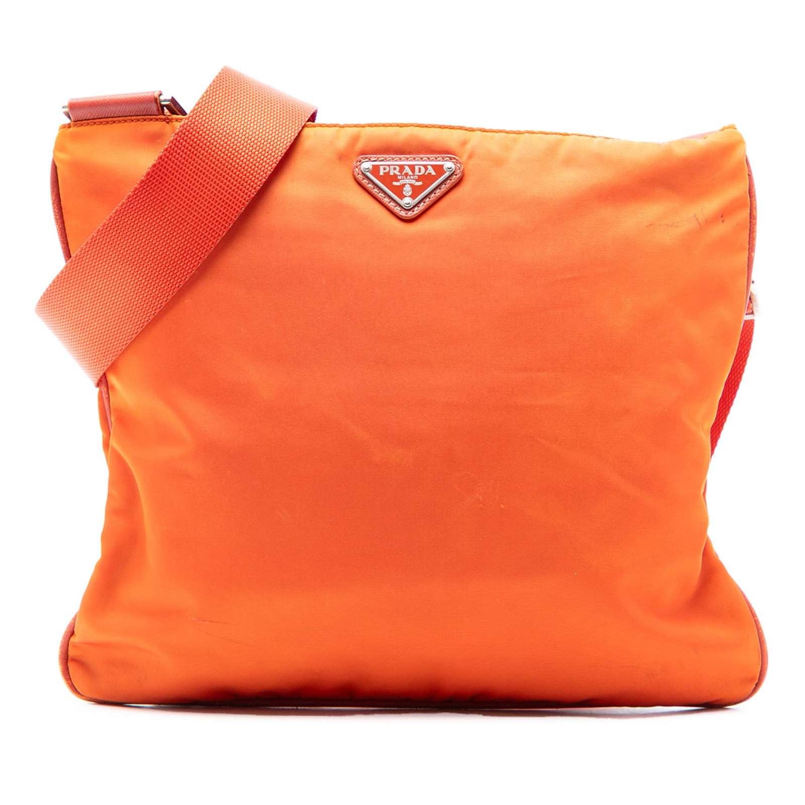 Prada Tessuto Orange Nylon Crossbody Bag with Zip Closure: Prada Tessuto Orange Nylon Crossbody Bag with Zip Closure This Prada Tessuto Zip Top Crossbody bag features an orange nylon fabric body with an adjustable flat canvas strap, a top zip closure, and an 