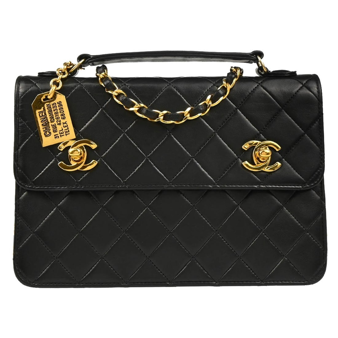 CHANEL CC black lambskin top handle bag with strap: CHANEL CC black lambskin top handle bag with strap Chanel 2way handbag in black lambskin with a top handle silhouette and logo accent. Made in France, this medium handbag features a leather lining, a 