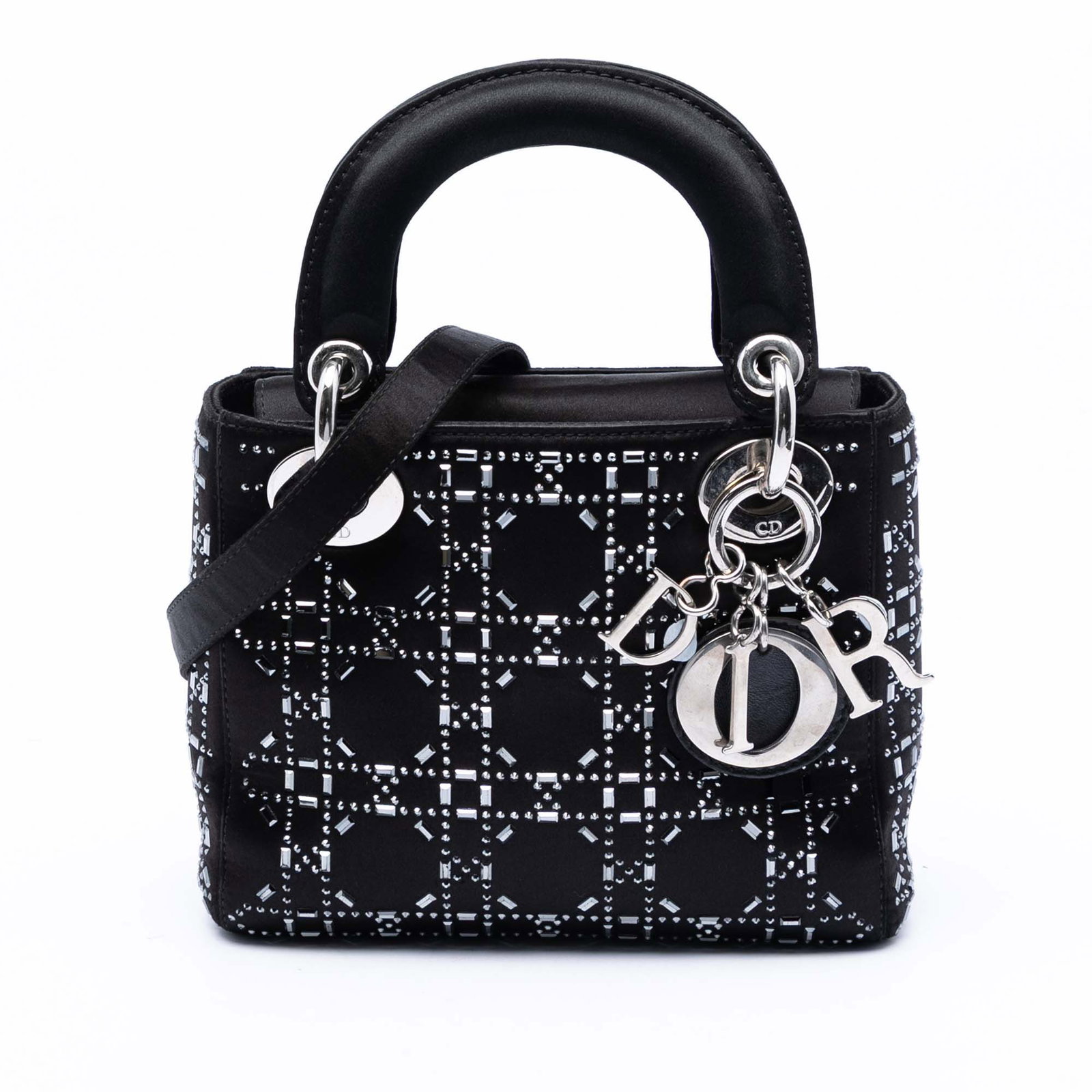 Dior Mini Lady Dior satin crystal embellished bag: Dior Mini Lady Dior satin crystal embellished bag This Lady Dior Mini bag showcases a black satin body adorned with crystal embellishments, complemented by flat satin handles and a detachable strap. I