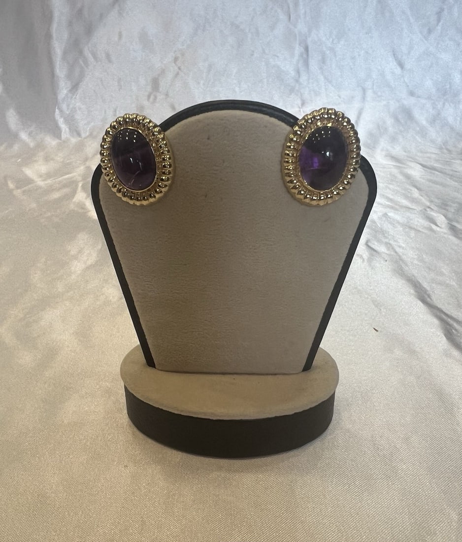 14k Gold Amethyst Cuff Earrings Pair Signed Hallmarked: 14k Gold Amethyst Cuff Earrings Pair Signed Hallmarked This exquisite pair of earrings features amethyst gemstones set in 14k gold. Designed in a cuff style, the earrings showcase intricate detailing 