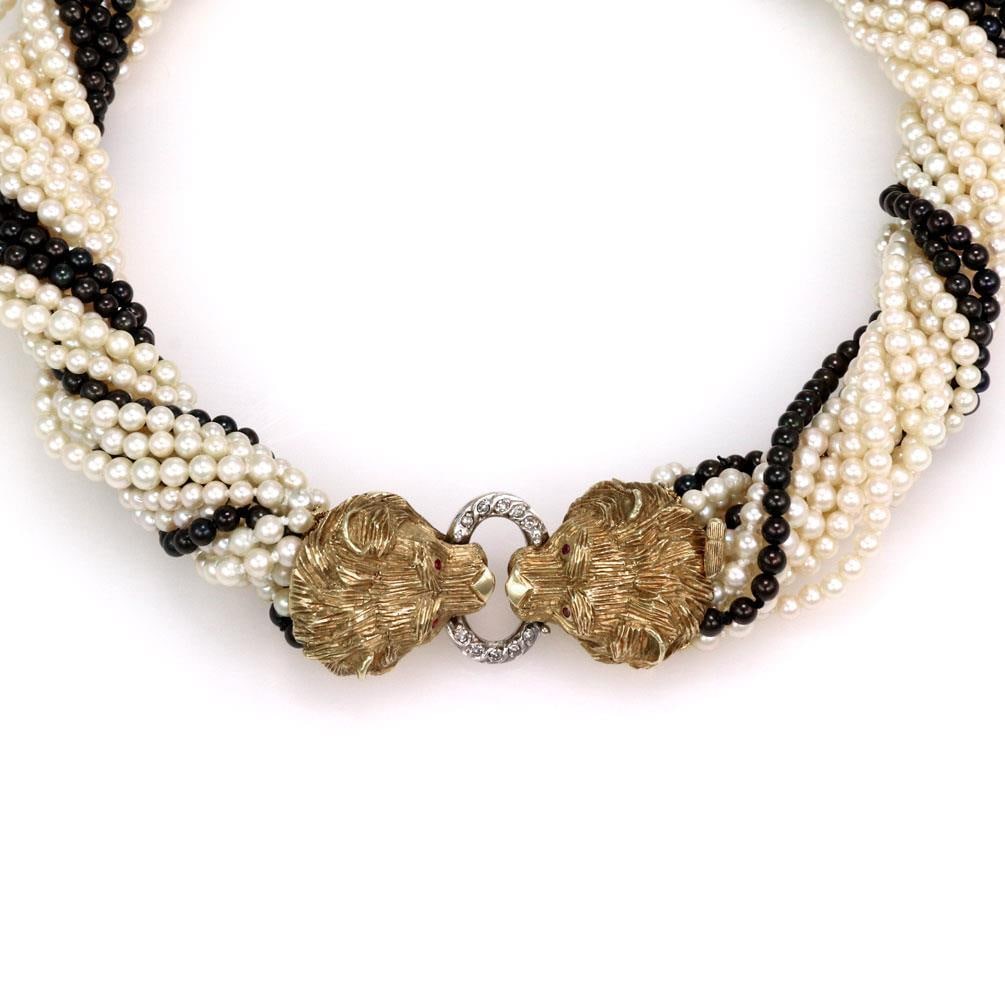 Estate 18k Gold Lion Pearl Necklace with Diamond Ruby Eyes: Estate 18k Gold Lion Pearl Necklace with Diamond Ruby Eyes This exquisite Estate necklace features a luxurious combination of 12 creamy white pearls and 3 strands of striking black pearls, elegantly a