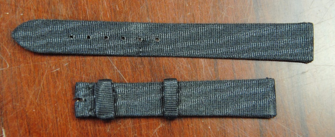 Chopard Authentic Black Fabric Wristwatch Band 13mm: Chopard Authentic Black Fabric Wristwatch Band 13mm Enhance your timepiece with this Chopard factory original black fabric wristwatch band. Designed with a width of 13mm and a length of 11mm, this str