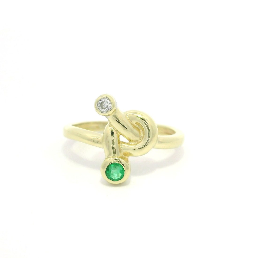 14k Yellow Gold Emerald Diamond Knot Band Ring: 14k Yellow Gold Emerald Diamond Knot Band Ring This exquisite ring features a polished knot design crafted from solid 14k yellow gold. At its center, it showcases a vibrant natural emerald, expertly c