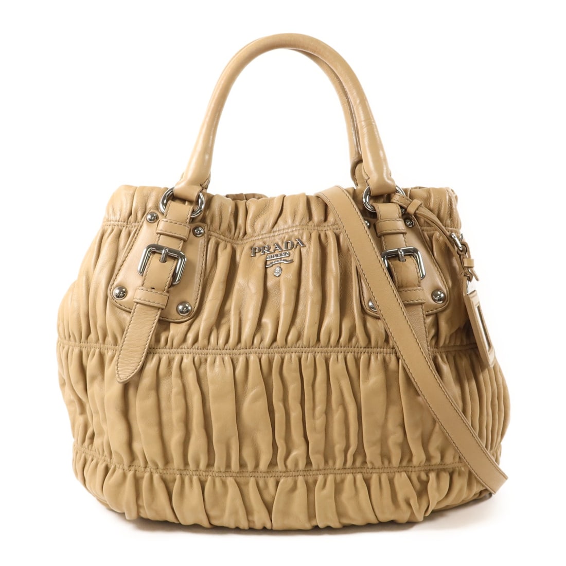 Prada Nappa Gaufre Lambskin 2 Way Bag Beige with Strap: Prada Nappa Gaufre Lambskin 2 Way Bag Beige with Strap A PRADA 2-way shoulder bag in beige Nappa Gaufre style, made from lambskin (sheep leather). It features a shoulder strap, name tag, magnetic pock
