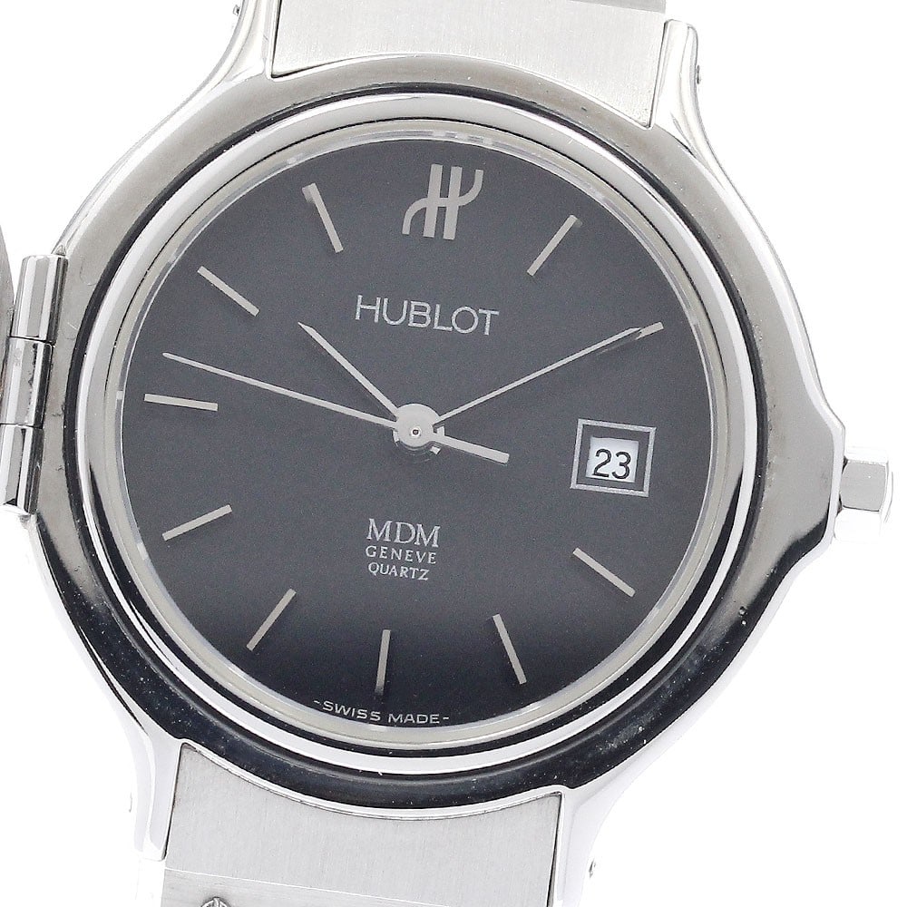 HUBLOT MDM Classic Women's Quartz Watch with Date Hunter Case: HUBLOT MDM Classic Women's Quartz Watch with Date Hunter Case HUBLOT MDM Classic Date Hunter Case Quartz women's wristwatch. This pre-owned watch is made in Switzerland and features a stainless steel 