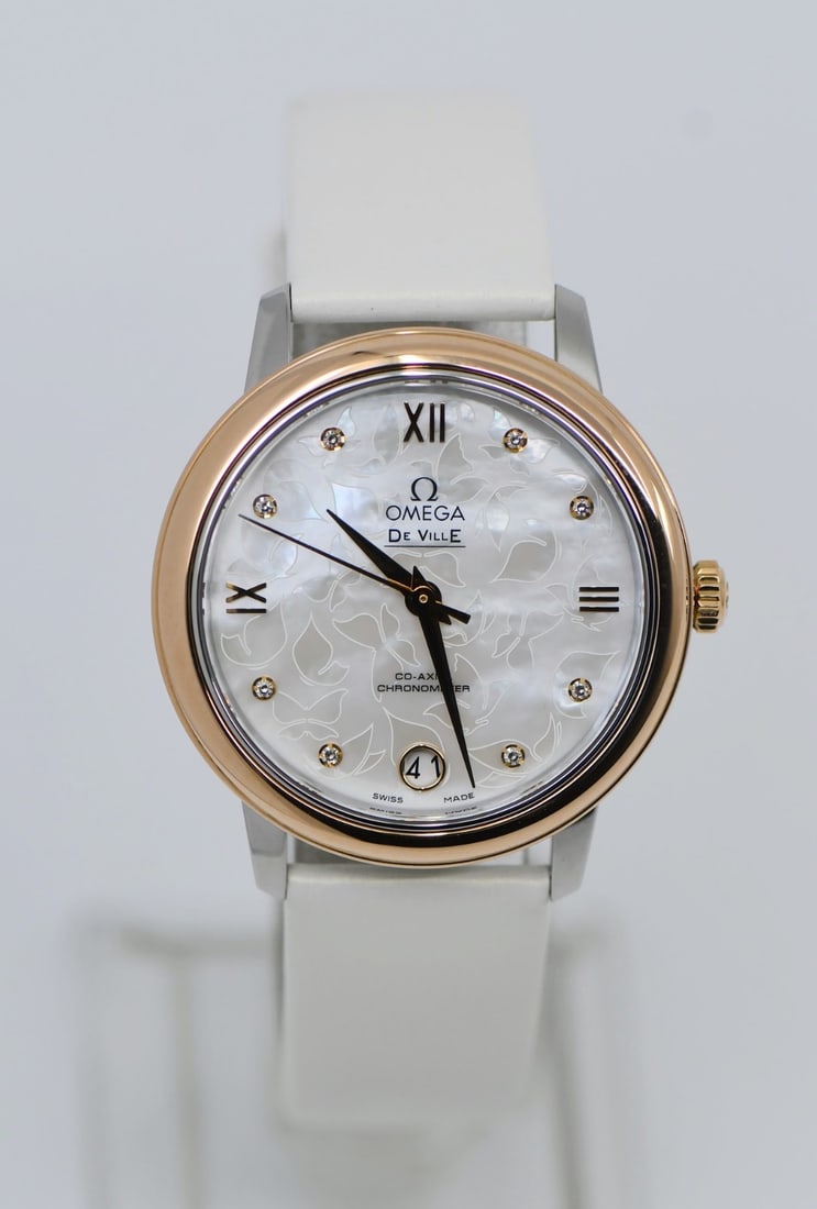 De Ville Prestige Mother of Pearl Dial 18K Gold Diamond Omega Watch Ref 424.22.33.20.55.001: De Ville Prestige Mother of Pearl Dial 18K Gold Diamond Omega Watch Ref 424.22.33.20.55.001 This Omega DeVille Prestige wristwatch features a 33mm stainless steel case accented with an 18K bezel set w