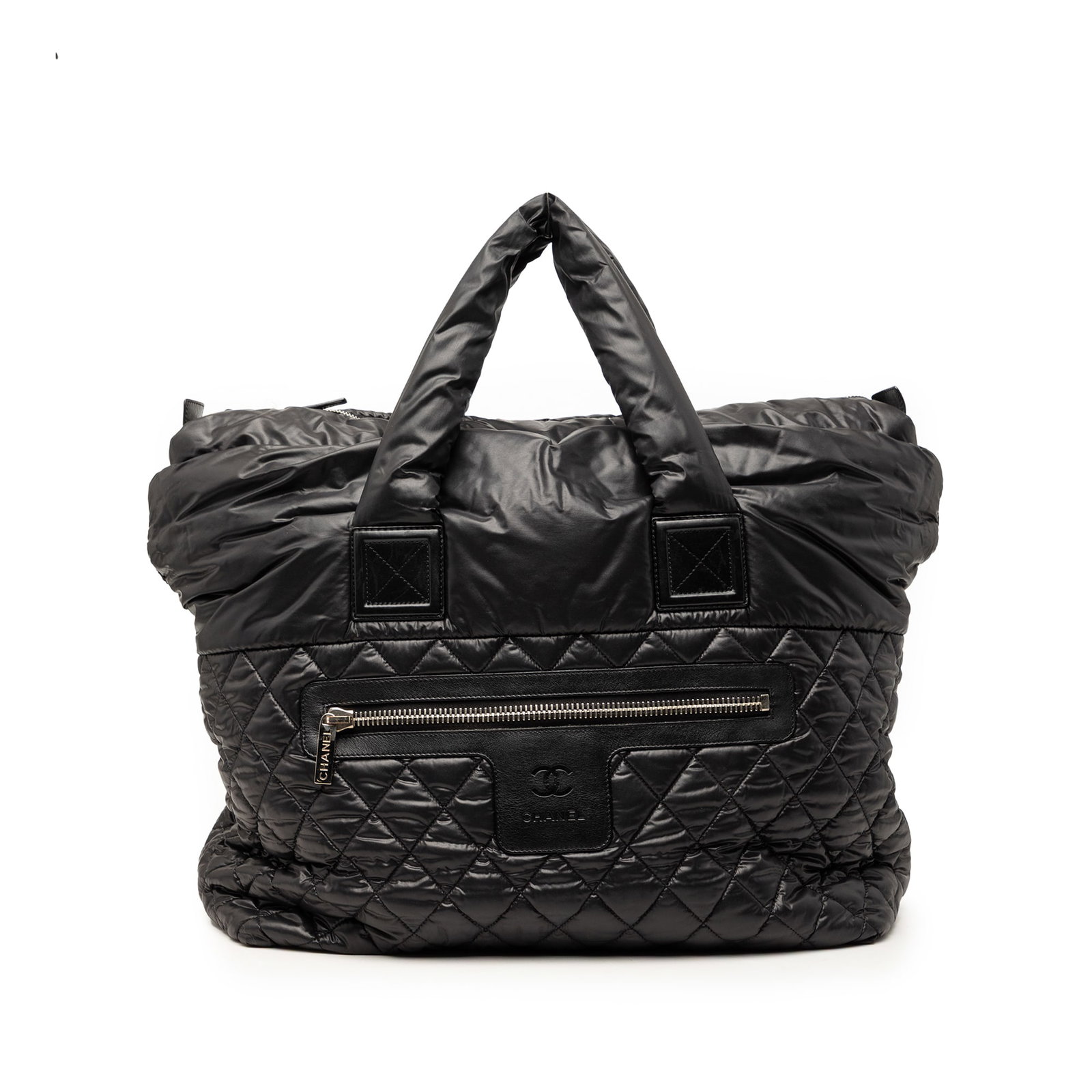 Chanel Coco Cocoon reversible nylon quilted tote: Chanel Coco Cocoon reversible nylon quilted tote This Chanel Large Quilted Nylon Reversible Coco Cocoon Tote features a nylon and leather body with a quilted design, rolled handles, an open top with a